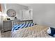 Nicely decorated bedroom with checkered patterns on the bed, circular mirror, and soft natural lighting at 8140 Bold Forbes Ct, Indianapolis, IN 46217