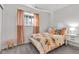 Inviting bedroom with a floral comforter, peach accents, and soft, natural light at 8140 Bold Forbes Ct, Indianapolis, IN 46217