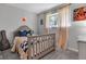 Comfortable bedroom with a sporty theme, soft natural lighting, and stylish decor elements at 8140 Bold Forbes Ct, Indianapolis, IN 46217