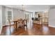 Dining area with hardwood floors, modern chandelier, and a view of the kitchen and backyard at 8140 Bold Forbes Ct, Indianapolis, IN 46217