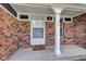 Welcoming covered front porch featuring brick accents, a 'Hello' doormat and house number at 8140 Bold Forbes Ct, Indianapolis, IN 46217