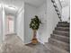 Hallway with grey carpet, stairs, white trim, and a view into a bathroom at 8140 Bold Forbes Ct, Indianapolis, IN 46217