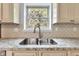 Kitchen details with decorative backsplash, stainless sink, granite countertops and wooden cabinetry at 8140 Bold Forbes Ct, Indianapolis, IN 46217