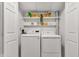 Laundry room featuring side-by-side washer and dryer units with shelving at 8140 Bold Forbes Ct, Indianapolis, IN 46217