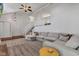 Open living room with large sectional sofa, brick fireplace, and staircase with white railings at 8140 Bold Forbes Ct, Indianapolis, IN 46217