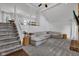 Spacious living room features gray carpet, a modern sofa and staircase at 8140 Bold Forbes Ct, Indianapolis, IN 46217