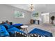 Cozy living room with a blue sectional, modern lighting, and a flat-screen TV, perfect for relaxing and entertaining at 8140 Bold Forbes Ct, Indianapolis, IN 46217