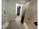 Bathroom featuring a white toilet, shower/bath and tile flooring with an open doorway to other rooms at 8407 Campbell Ct, Mooresville, IN 46158