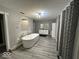 Bright bathroom featuring a modern soaking tub and double sink vanity with plenty of light at 8407 Campbell Ct, Mooresville, IN 46158