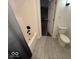 Bathroom featuring a white toilet, shower/bath and tile flooring with an open doorway to other rooms at 8407 Campbell Ct, Mooresville, IN 46158