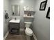 Small half bath featuring a modern vanity, mirror and toilet at 8407 Campbell Ct, Mooresville, IN 46158