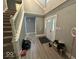 Inviting entryway features hardwood floors, white trim, and a charming staircase at 8407 Campbell Ct, Mooresville, IN 46158