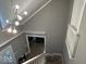 View from above into the entryway with hardwood floors, staircase, and modern light fixture at 8407 Campbell Ct, Mooresville, IN 46158