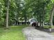 Home exterior boasts a long driveway, mature trees, and a well-manicured lawn at 8407 Campbell Ct, Mooresville, IN 46158