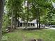 Home exterior boasts a long driveway, mature trees, and a well-manicured lawn at 8407 Campbell Ct, Mooresville, IN 46158