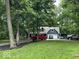 Home exterior boasts a long driveway, mature trees, and a well-manicured lawn at 8407 Campbell Ct, Mooresville, IN 46158