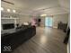 Open living room with hardwood floors, gray fireplace, and neutral decor at 8407 Campbell Ct, Mooresville, IN 46158