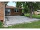 Backyard view of home with brick accents and newly installed paver patio at 8905 Maze Rd, Indianapolis, IN 46259