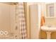 Bathroom featuring a shower with curtain and vanity with pedestal sink at 8905 Maze Rd, Indianapolis, IN 46259