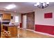 Eat-in kitchen featuring an island, white door, and hardwood floors at 8905 Maze Rd, Indianapolis, IN 46259