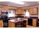 Kitchen featuring black appliances, granite counters, and an island with seating at 8905 Maze Rd, Indianapolis, IN 46259