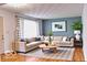 Comfortable living room with a large sectional sofa, hardwood floors, and a modern aesthetic at 8905 Maze Rd, Indianapolis, IN 46259