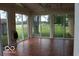 Bright sun room with multiple glass doors overlooking a large yard at 8905 Maze Rd, Indianapolis, IN 46259