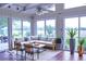 Bright sunroom featuring large windows, cozy seating, and terracotta tile flooring at 8905 Maze Rd, Indianapolis, IN 46259
