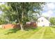Spacious backyard showcasing lush green grass and a large shade tree at 8925 Sunburst Cir, Indianapolis, IN 46227