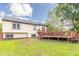 Home featuring large wood deck and partially fenced yard at 8925 Sunburst Cir, Indianapolis, IN 46227