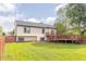 Expansive backyard featuring a well-maintained lawn, wood deck, and partial fence at 8925 Sunburst Cir, Indianapolis, IN 46227