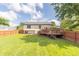Home featuring large wood deck and partially fenced backyard at 8925 Sunburst Cir, Indianapolis, IN 46227