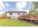View of home's back exterior with walkout basement and wooden deck at 8925 Sunburst Cir, Indianapolis, IN 46227