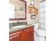 Well-lit bathroom with a vanity, granite counter, framed mirror, and stylish decor at 8925 Sunburst Cir, Indianapolis, IN 46227