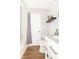 Bright bathroom with subway tile shower, wood-look floors, and a modern vanity at 8925 Sunburst Cir, Indianapolis, IN 46227