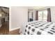 Spacious bedroom features a queen bed, wood floors, and natural light from the window at 8925 Sunburst Cir, Indianapolis, IN 46227