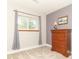 Bedroom featuring carpet, ample sunlight, and wooden dresser at 8925 Sunburst Cir, Indianapolis, IN 46227