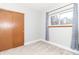 Bedroom features plush carpeting, a closet, and a large window offering abundant natural light at 8925 Sunburst Cir, Indianapolis, IN 46227