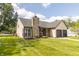 Home with attached garage, stone chimney, manicured lawn, flowers and landscaping for curb appeal at 8925 Sunburst Cir, Indianapolis, IN 46227