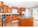 Spacious kitchen featuring wood cabinets, granite countertops, stainless steel appliances, and center island at 8925 Sunburst Cir, Indianapolis, IN 46227