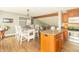 Bright kitchen and dining area featuring wood cabinets and an island with bar seating at 8925 Sunburst Cir, Indianapolis, IN 46227