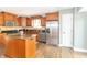 Well-lit kitchen with wooden cabinetry, stainless steel appliances, and a granite island at 8925 Sunburst Cir, Indianapolis, IN 46227