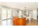 Open-concept kitchen and dining area with wood cabinets and a center island at 8925 Sunburst Cir, Indianapolis, IN 46227