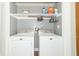 Functional laundry room with modern washer and dryer units and shelving for storage at 8925 Sunburst Cir, Indianapolis, IN 46227