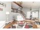 Bright living room with soaring ceilings, beams, staircase, hardwood floors, and a large, decorative rug at 8925 Sunburst Cir, Indianapolis, IN 46227