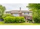 Rear exterior of a two-story house featuring a patio, large windows, and a well-manicured lawn at 9237 Rocky Cay Ct, Zionsville, IN 46077