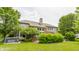 Back of a house with a large yard, trees, and a hot tub at 9237 Rocky Cay Ct, Zionsville, IN 46077