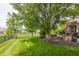 A spacious backyard with manicured lawn, patio, and a view of the pond at 9237 Rocky Cay Ct, Zionsville, IN 46077