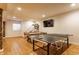 Basement game room with ping pong table, hardwood floors, and recessed lighting, perfect for entertainment at 9237 Rocky Cay Ct, Zionsville, IN 46077