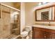 Finished basement bathroom features glass shower, stone tile, and wooden vanity at 9237 Rocky Cay Ct, Zionsville, IN 46077